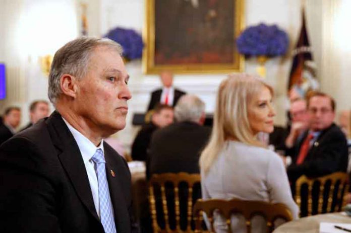 Washington State Governor Jay Inslee (L) listens to participants as U.S. President Donald Trump holds a discussion about school shootings with state governors from around the country at the White House in Washington, U.S,. February 26, 2018. REUTERS/Jonathan Ernst