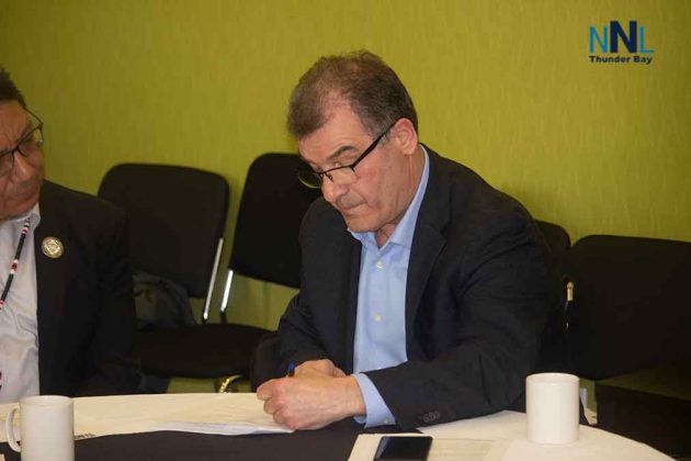 Kenora MP Bob Nault signs the agreement in Thunder Bay