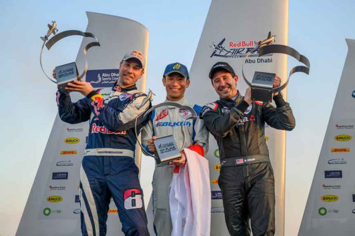Yoshihide Muroya of Japan (C) celebrates with Martin Sonka of the Czech Republic (L) and Michael Goulian of the United States (R) during the Award Ceremony at the first round of the Red Bull Air Race World Championship at Abu Dhabi, United Arab Emirates on February 9, 2019. Photographer Credit: Joerg Mitter / Red Bull Content Pool