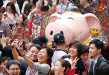 Stop Pigging out and Save the Planet, Chinese told ahead of Lunar New Year Visitors take pictures of an installation at a flower fair ahead of the Chinese Lunar New Year of the Pig, in Guangzhou, Guangdong province, China February 3, 2019. Picture taken February 3, 2019. REUTERS/Stringer