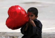 Love in the time of Climate Change – Valentine’s Traditions at Risk A boy inflates a heart-shaped balloon to sell on Valentine's Day in Karachi, Pakistan February 14, 2016. REUTERS/Akhtar Soomro