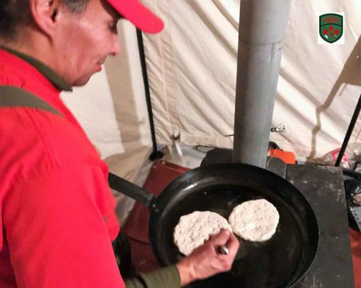 Master Corporal Floyd Fiddler makes traditional bannock in preference to army rations. Image Credit: Master Corporal Jason Hunter, Canadian Rangers