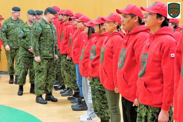 Brigadier-General Jocelyn Paul inspects newly graduated Canadian Rangers in Pikangikum.