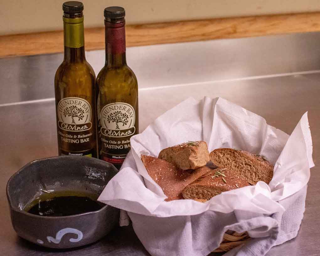 Photo Credit - Claudia Ochnicki Photography: Homemade fresh baked focaccia cut in wedges and served with balsamic and olive oil from A Fine Fit Catering and Consulting