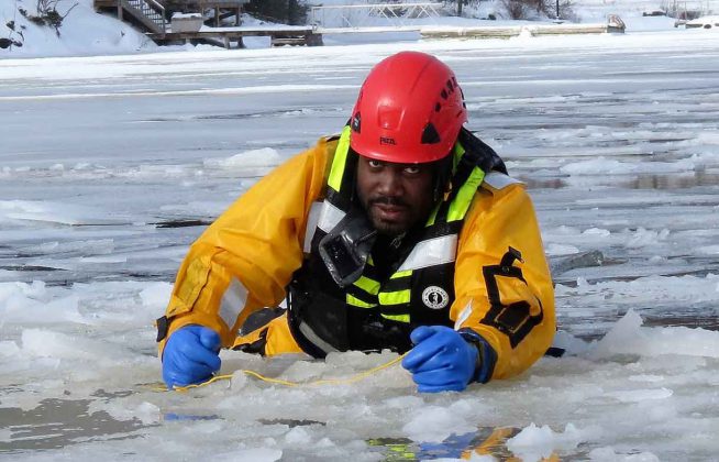 Sergeant Eric Scott hauls himself out of broken ice during ice rescue training.