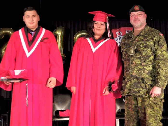 Tyler Tait, left, and Christyn Koostachin, centre, two of five Junior Canadian Rangers who have graduated from Dennis Franklin Cromarty High School in Thunder Bay, with Captain John McNeil, right, the Canadian Army officer commanding Junior Rangers in Northern Ontario - Photo Credit 2nd Lt. Jack Teskey