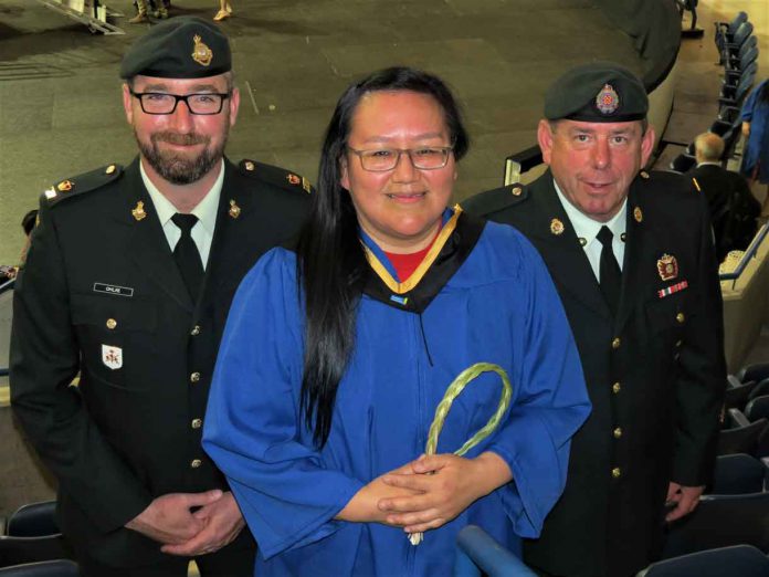 Master Corporal Jocelyne Sutherland of Fort Albany,centre, with Major Charles Ohlke, left, and Master Warrant Officer Barry Borton, after receiving her bachelor of social work degree.