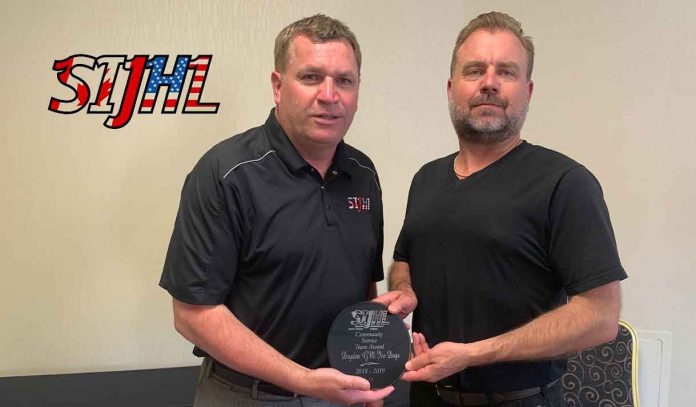 SIJHL commissioner Bryan Graham (left) presents the league's 2nd Annual Community Service Award to Dryden GM Ice Dogs president Michael Sveinson (right).
