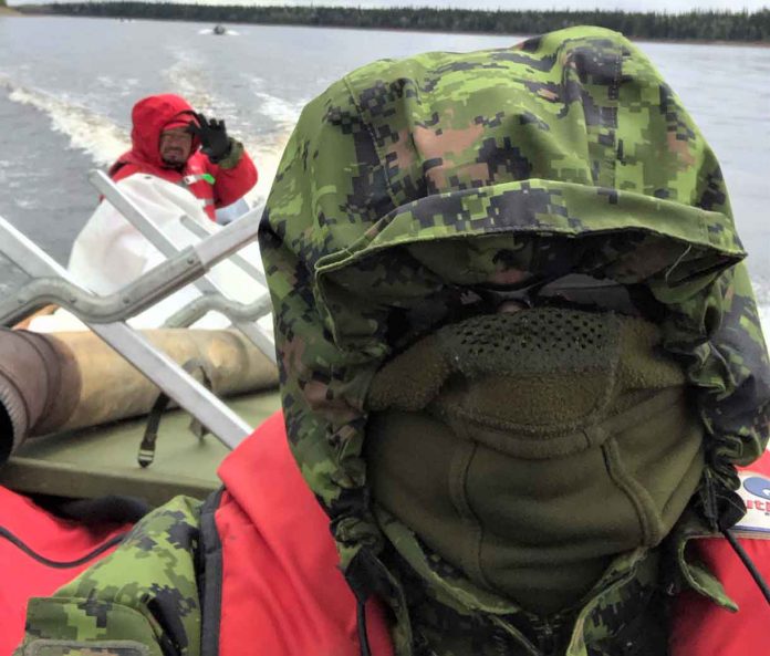 Sergeant Thomas Scott of Fort Albany, left, and Warrant Officer Carl Wolfe bundle up against the cold during the river patrol.