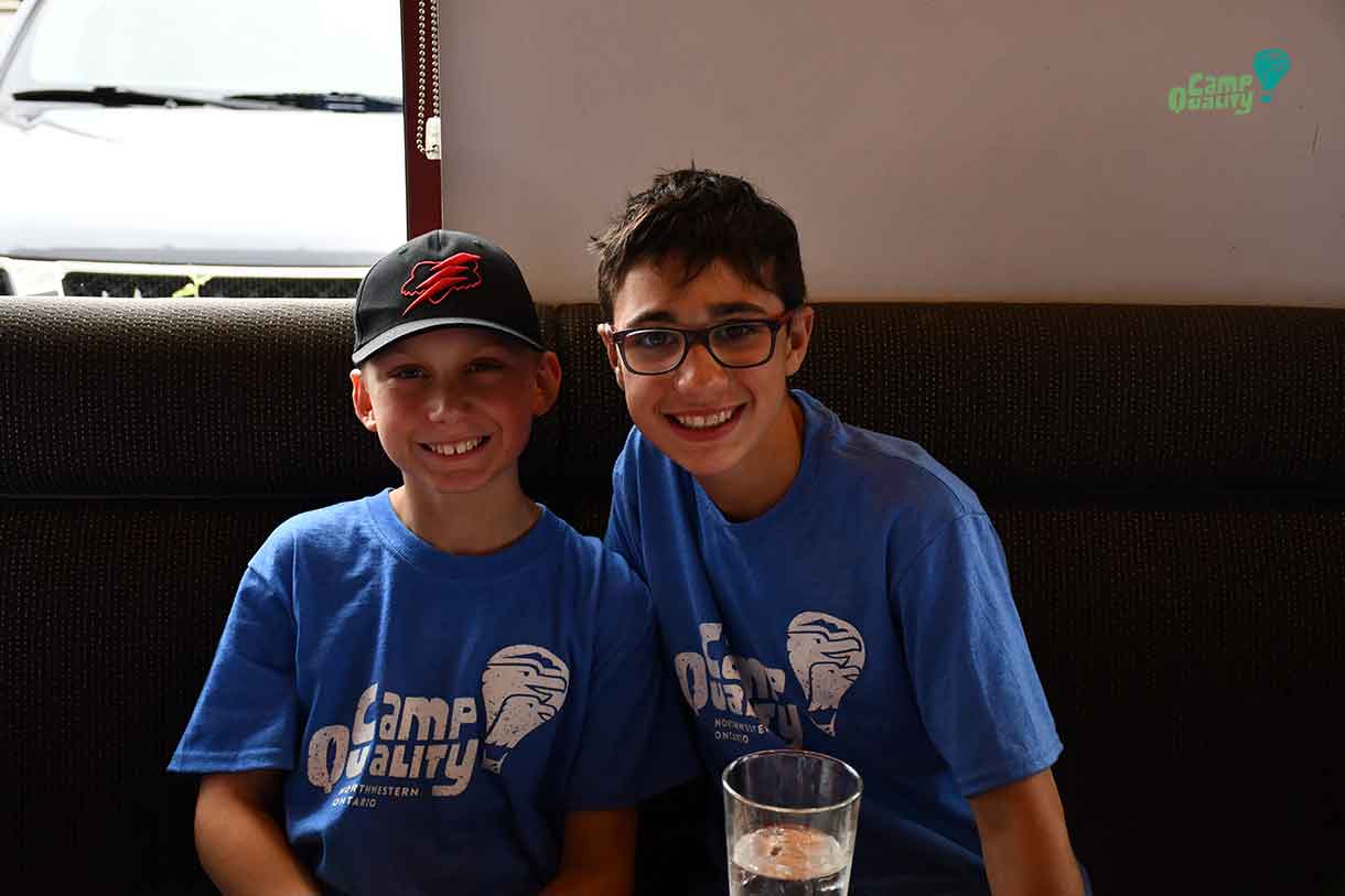 Campers Denver and Lucas enjoying their meal from Boston Pizza.