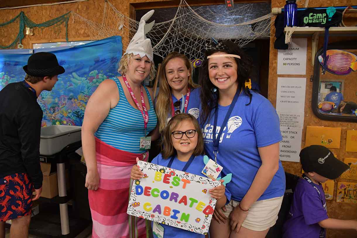 Back row from left: Director Ashleigh, Co-Programming Coordinator Jaimie, and Companion Victoria. Front row: Camper Sammy holding the “Best Decorated Cabin” award. Congratulations!