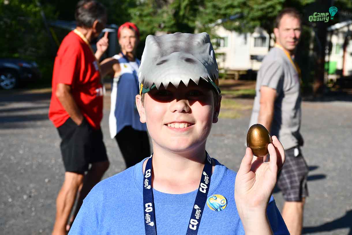 Camper Gryphon showing off his Golden Egg – his ticket to the front of the lunch line tomorrow! He’s also sporting a really cool dinosaur cap.