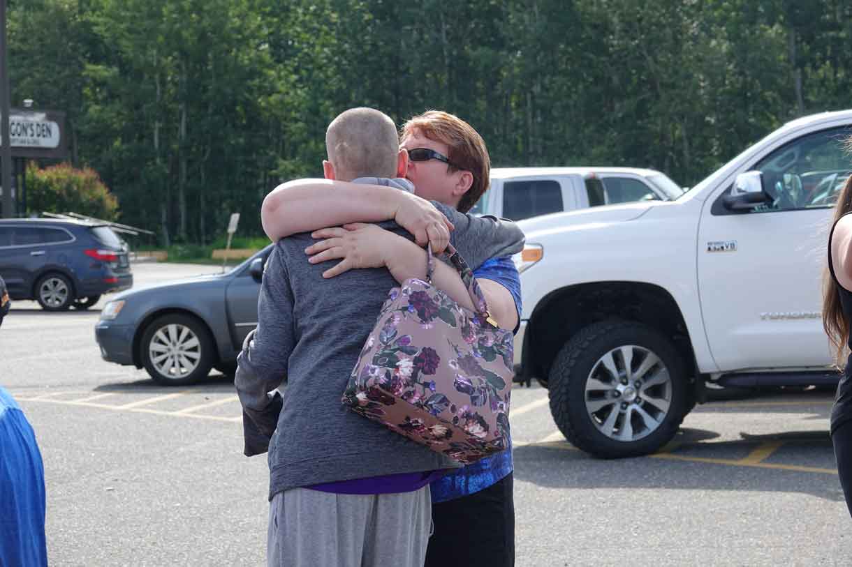 Camper Alex saying goodbye to his mom, Cathy at camp pick-up.