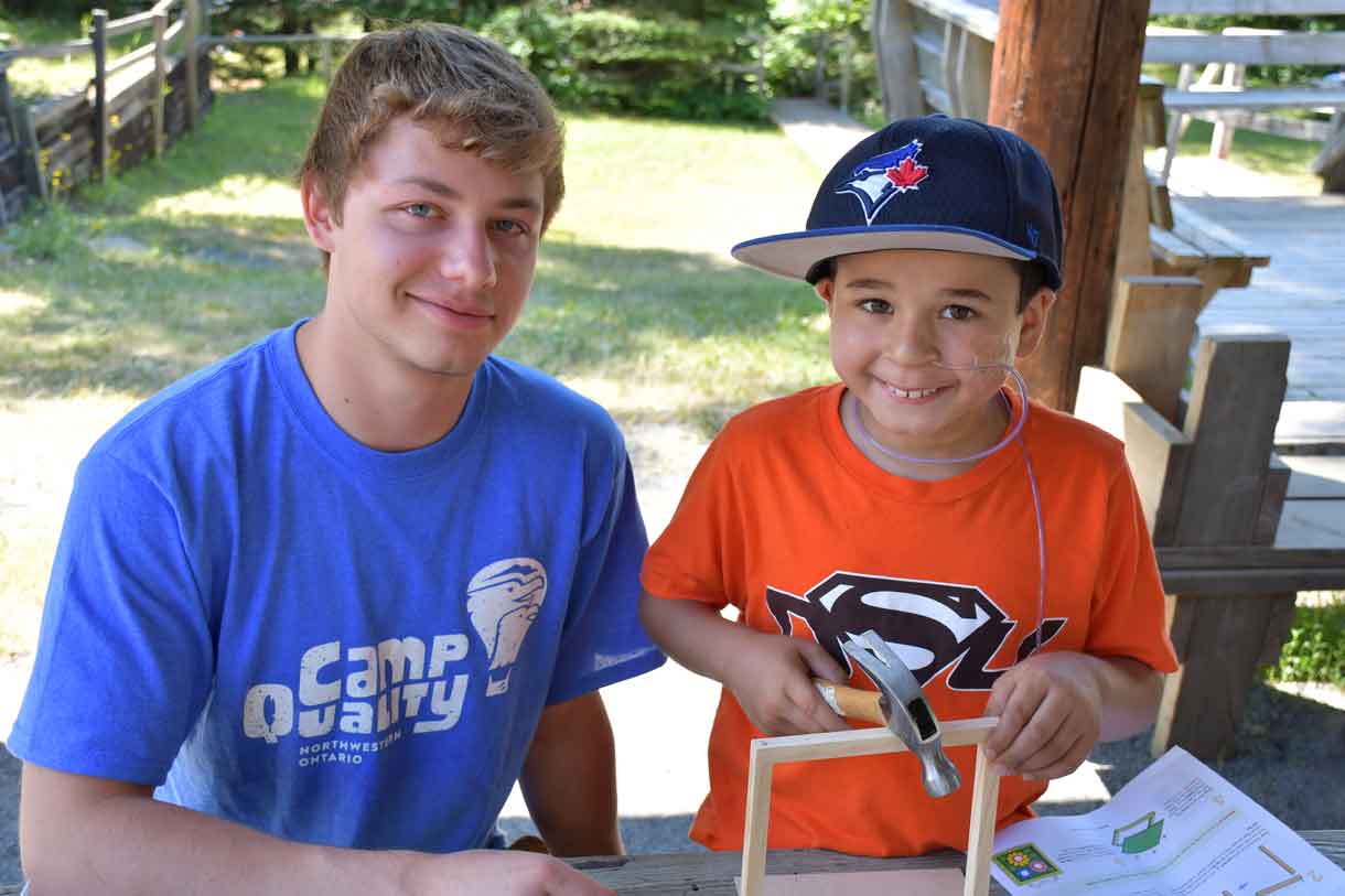 Camper Alessio (right) building a Home Depot craft with Companion Branden (left)