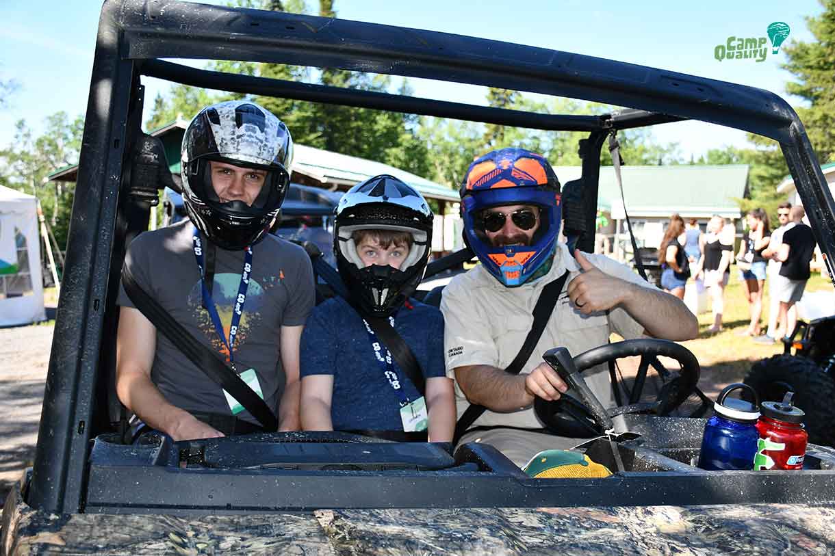 Companion Josh (left) and camper Gryphon (middle) taking a ride with Daniel (AKA Ranger Rick) through the safari!