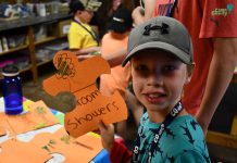 Camp Quality Blog Day 3 – Tuesday, July 16, 2019 Camper Ryder shows off a piece of the Treasure Map Puzzle