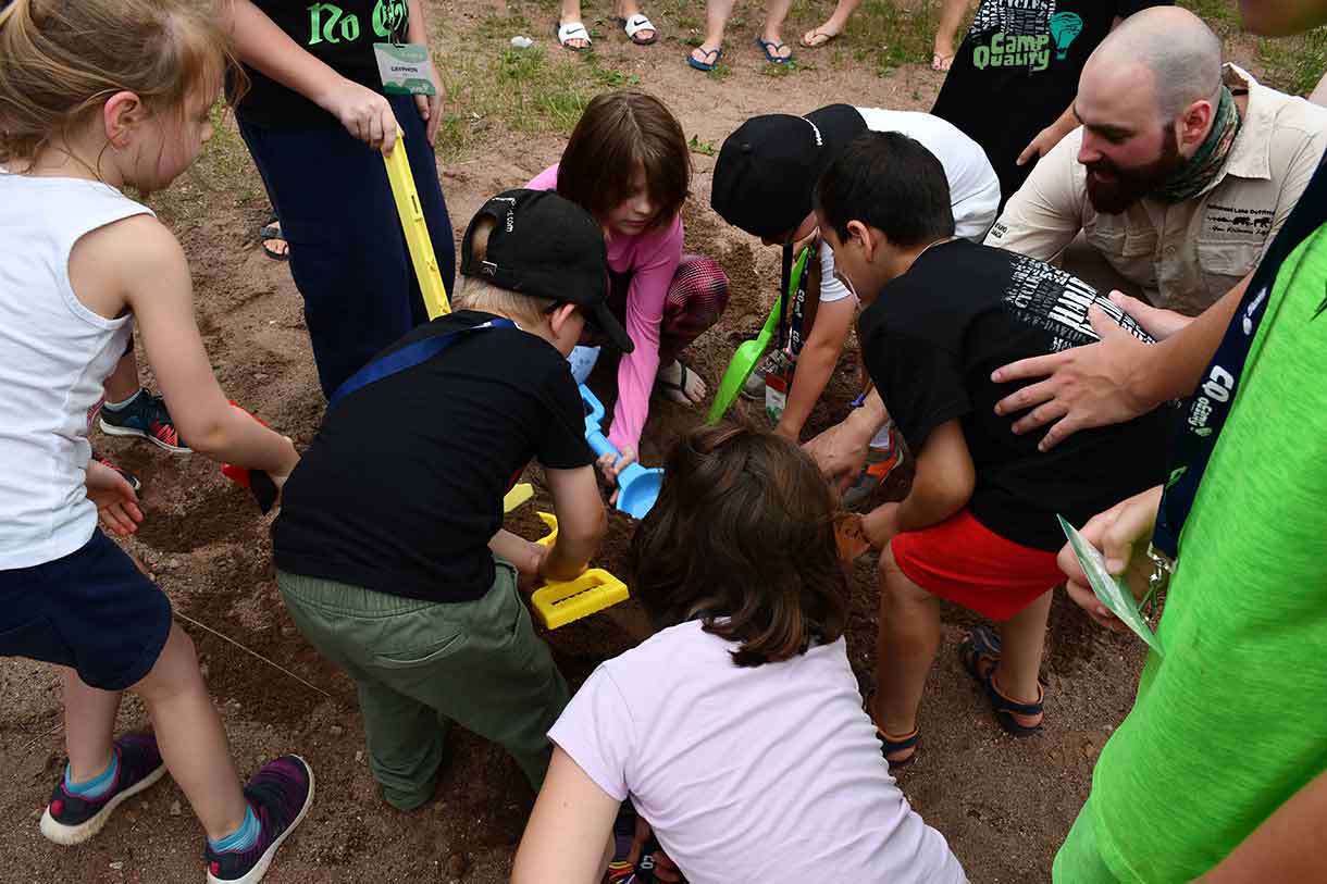 A group of campers working as a team to uncover the treasure!