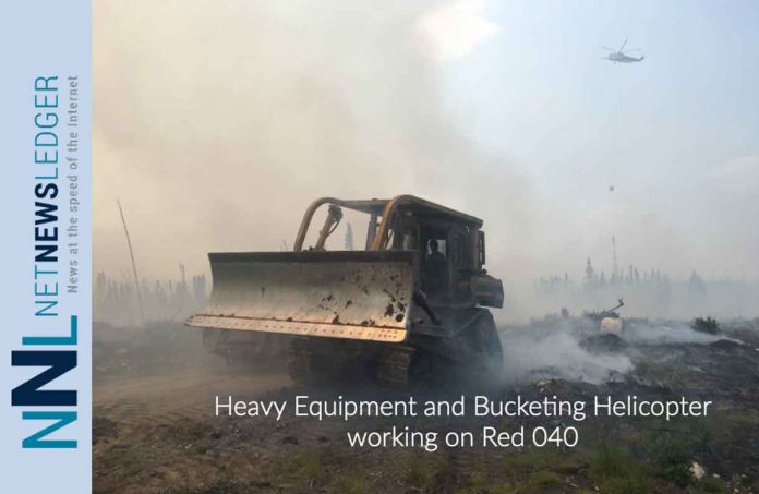 Heavy Equipment and Bucketing Helicopter working on Red 040