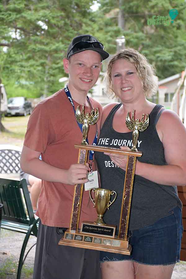 Camper Alex (left) holding the Quinten Spirit Award, with Camp Director Ashleigh.