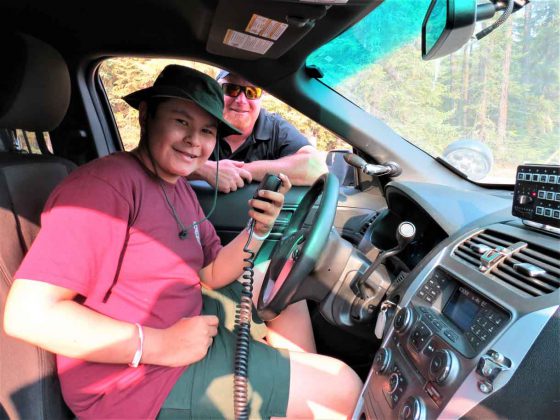 Constable Gary Camberly shows Junior Canadian Ranger Tanner Wesley of Constance Lake how the radio works in a Thunder Bay Police cruiser. credit Sergeant Peter Moon, Canadian Rangers