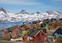 Europe’s record heatwave threatens Greenland ice sheet ARCHIVE PHOTO: Snow covered mountains rise above the harbour and town of Tasiilaq, Greenland, June 15, 2018. REUTERS/Lucas Jackson/File Phot
