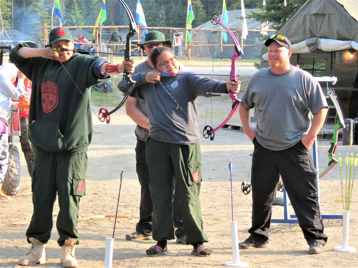 Constable Gary Camberly, right, with two Junior Canadian Rangers on the archery site at Camp Loon. Photo Sgt Peter Moon Canadian Rangers