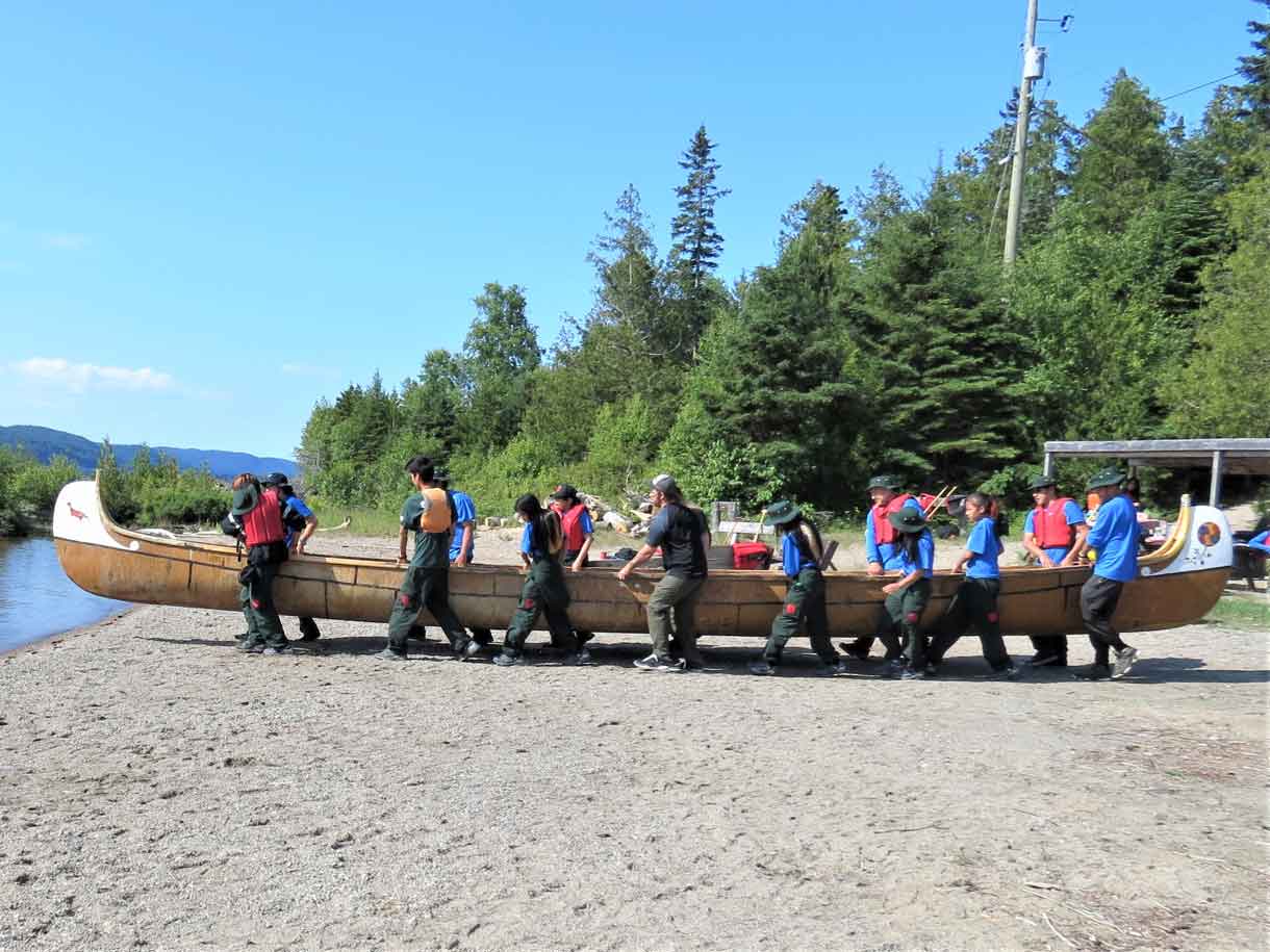 Junior Canadian Rangers carry a voyageur canoe into Lake Superior at Wawa to begin a five-day trip.