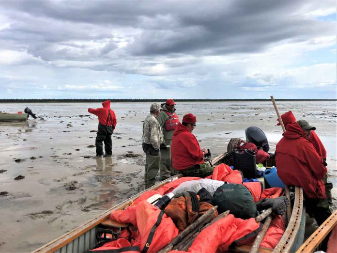 Canadian Rangers waiting for the tide to come in on James Bay so they can continue their patrol.
