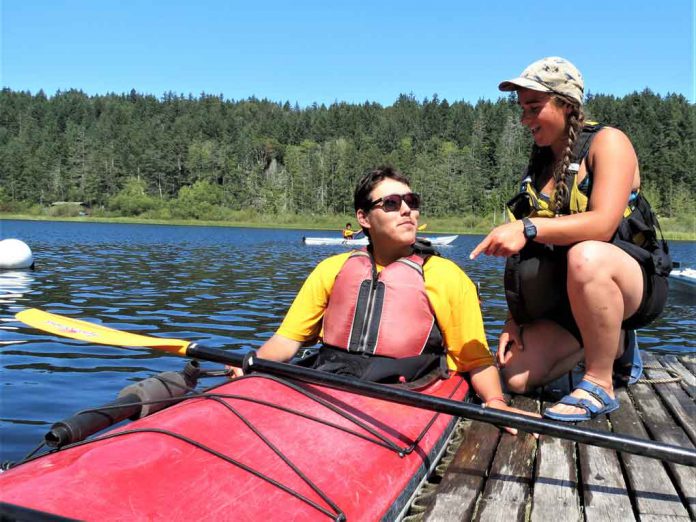 Junior Canadian Ranger Wilbert Shisheesh of Attawapiskat receives kayaking instructions from Maia Beauvais, a boating instructor.