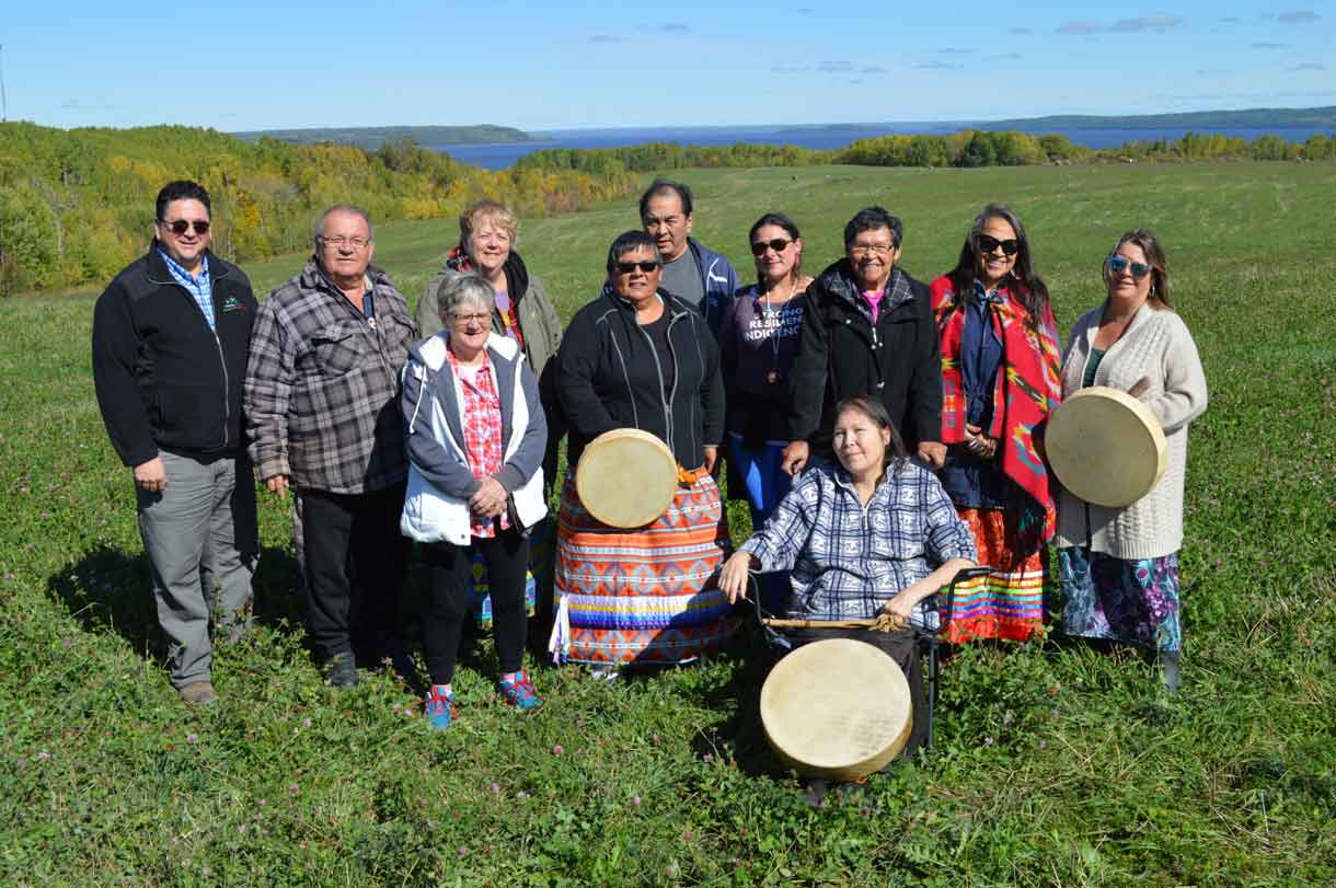 A Language Gathering that brother together Indigenous language speakers was held near North Cobalt, near Temiskaming and overlooking Lake Timiskaming from September 27 to 29. Pictured from L-R are representatives who made the event possible: Dani Grenier-Ducharme, District of Timiskaming Social Services Administration Board; Elder George Ethier, Temiskaming Metis Council; Elder Freda Wabie (in front), Beaverhouse FN; Elder Marie Liliane Ethier, Temiskaming Metis Council; Bertha Cormier, Matachewan FN; Elder Tom Wabie, Beaverhouse FN; Melissa Gill, Temiskaming Native Women's Support Group (TNWSG); Elder Vina Hendrix, Matachewan FN; Elder Roberta Oshkabewisens, TNWSG and Nancy Wabie, Beaverhouse FN. Seated in front is past Beaverhouse FN Chief, Elder Sally Susan Mathias Martel (Marcia Brown-Martel). 