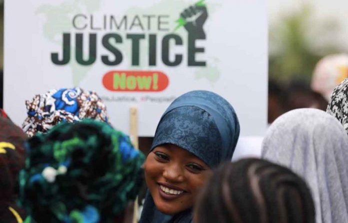 A protester smiles during a demonstration for climate protection in Abuja, Nigeria September 20, 2019. REUTERS/Afolabi Sotunde