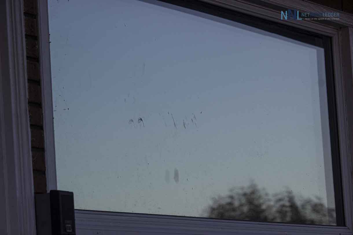 Damage to the window at the Lakehead Motel as a result of a large rock and chairs being thrown against it