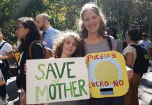 ‘They’re scared’: parents back child climate activists with hope Aaron Thomases, 9, and his mother Teresa Elguera at the climate strike outside City Hall in New York City on September 27, 2019. Thomson Reuters Foundation / Rachel Savage