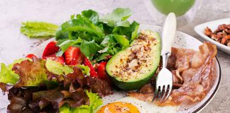 The Significance of Writing Down Non-Scale Victories in Weight Loss Plate with a Fried egg, bacon, avocado, arugula and strawberries.