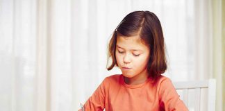 Yasmin Sarwar on the Kind Sentence That Quietly Teaches Children to Fear Maths Little girl is doing her homework for elementary school.
