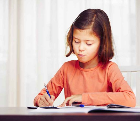 Yasmin Sarwar on the Kind Sentence That Quietly Teaches Children to Fear Maths Little girl is doing her homework for elementary school.