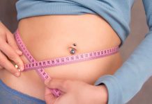 Ten ways to get rid of belly fat Young woman measuring her waist with pink tape