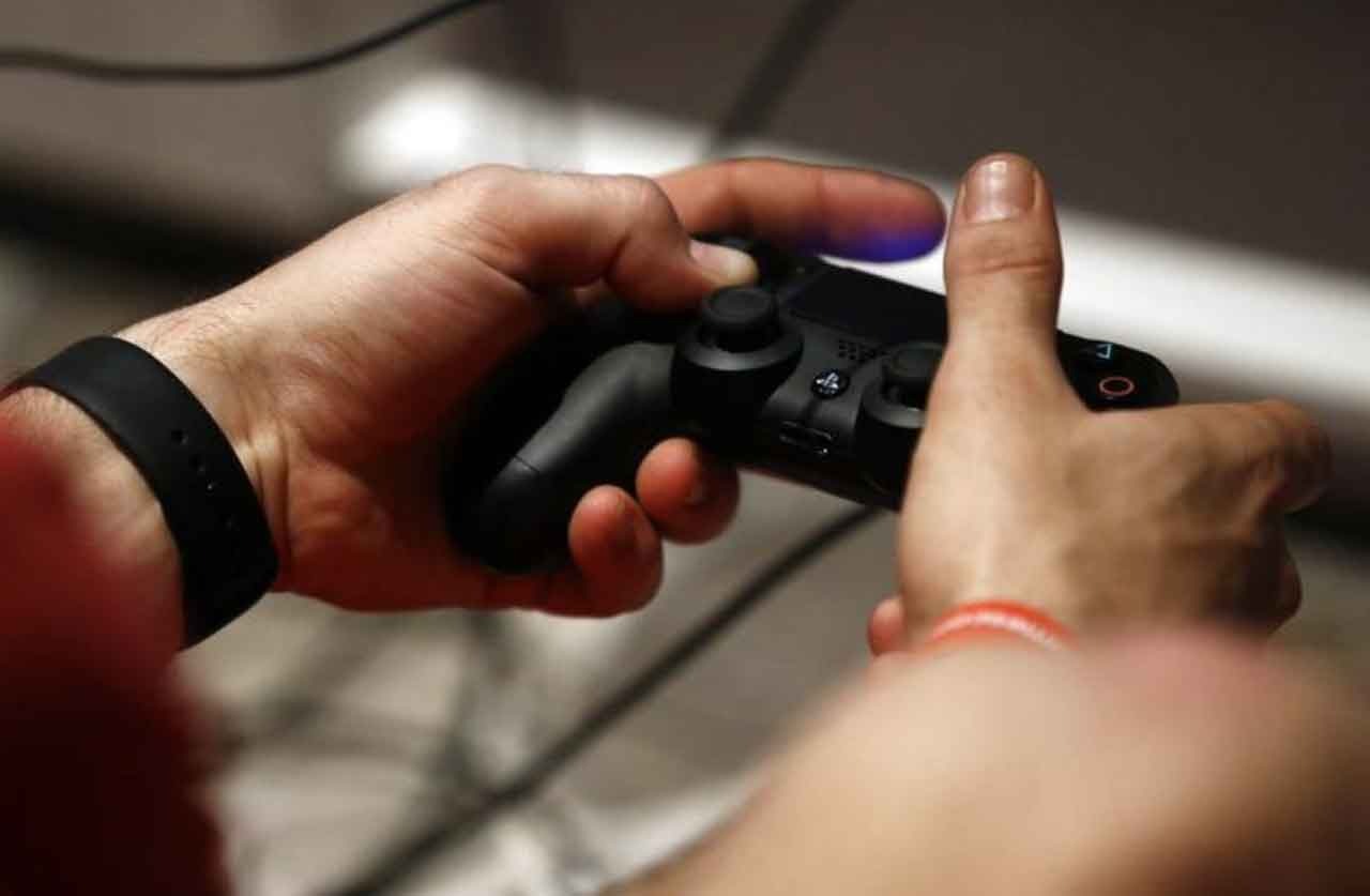Archive Photo: A man uses a Sony PlayStation controller during the Gamescom 2015 fair in Cologne, Germany August 6, 2015. The Gamescom convention, Europe's largest video games trade fair, runs from August 5 to August 9. REUTERS/Kai Pfaffenbach