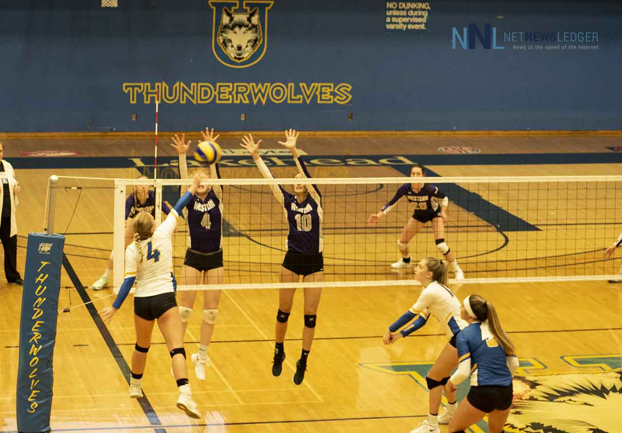 Lakehead Thunderwolf Megan Nahachewsky spikes the ball into the Western Mustangs Defence