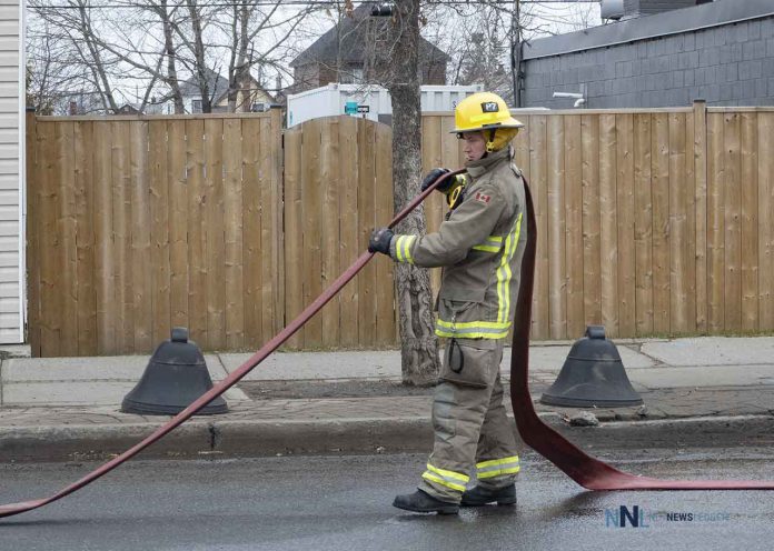Thunder Bay Fire Rescue - Firefighter cleaning up on Simpson Street