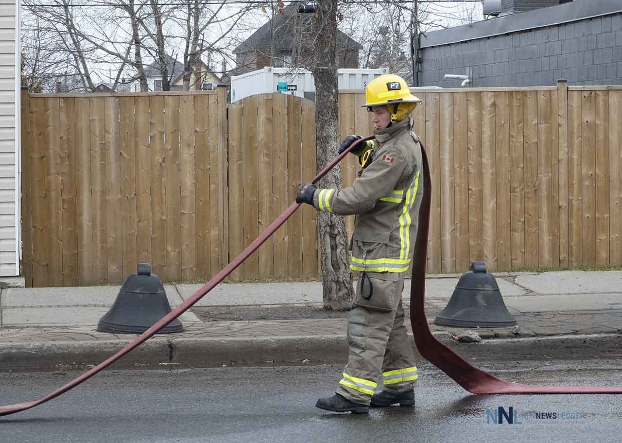 Thunder Bay Fire Rescue - Firefighter cleaning up on Simpson Street