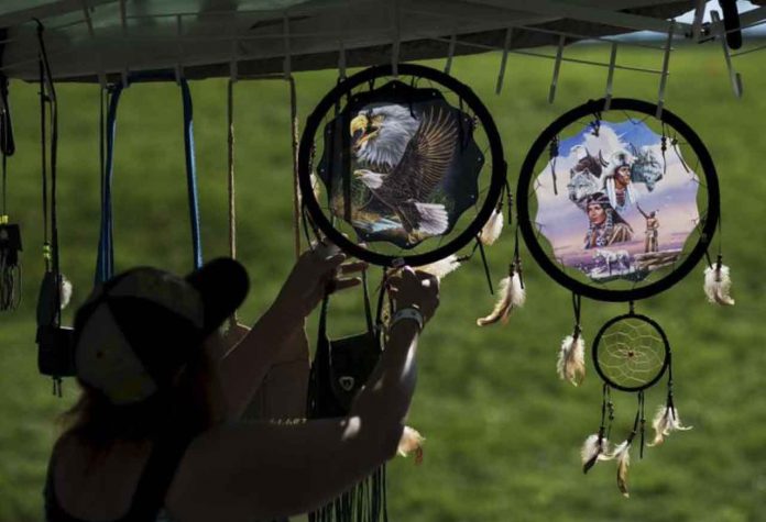 ARCHIVE PHOTO: A woman organizes indigenous items after a Sunrise Ceremony during a 