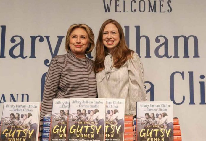 Hillary Clinton and Chelsea Clinton pose for pictures during an event for their new book 