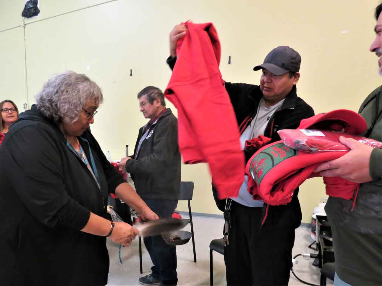 Aroland Elder Nora Atlookan smudges the uniform items issued to newly sworn-in Canadian Rangers