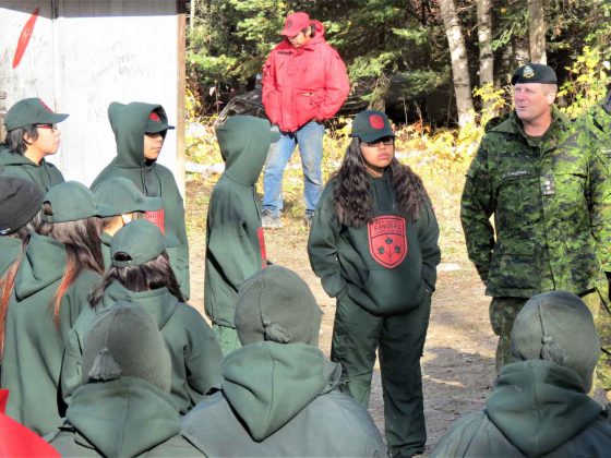 Lieutenant-Colonel Shane McArthur, right, talks with new Junior Canadian Rangers in Pikangikum First Nation