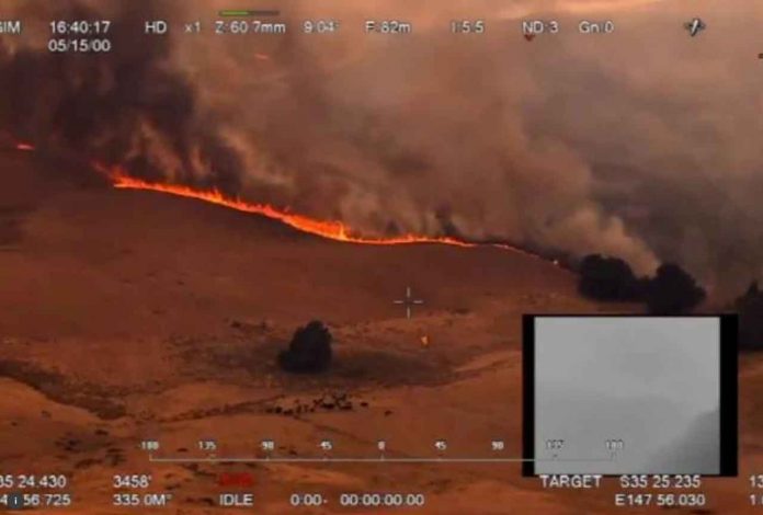 An aerial view of a bushfire in Ellerslie, New South Wales, Australia December 30, 2019 in this still image obtained from social media video. NSW RURAL FIRE SERVICE/via REUTERS