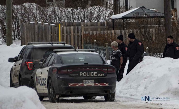 Thunder Bay Police officers with a suspect in custody after a manhunt on McCulloch Street.