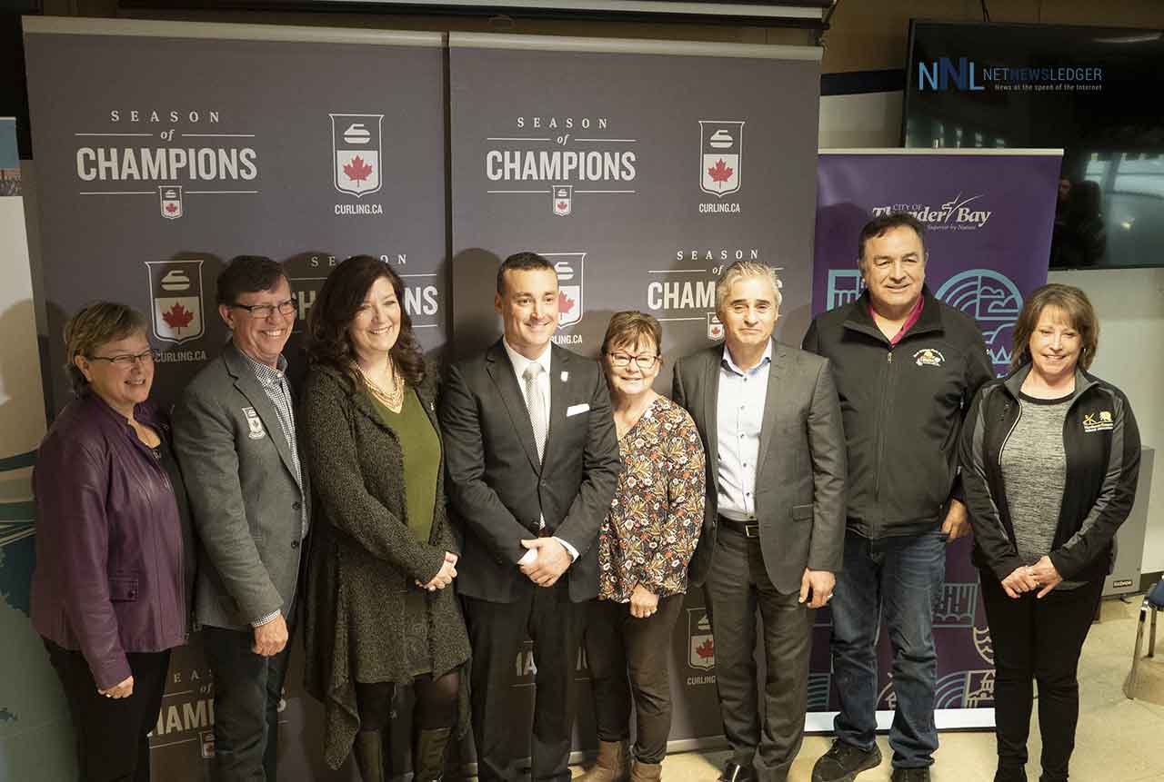 All smiles as dignitaries pose for picture at announcement at the Fort William Curling Club