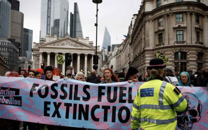 Protesters shout slogans as they block the road during an Extinction Rebellion demonstration at Bank, in the City of London, Britain October 14, 2019. REUTERS/Henry Nicholls