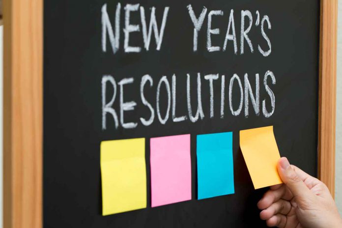 New Year resolutions or goals with sticky notes on blackboard